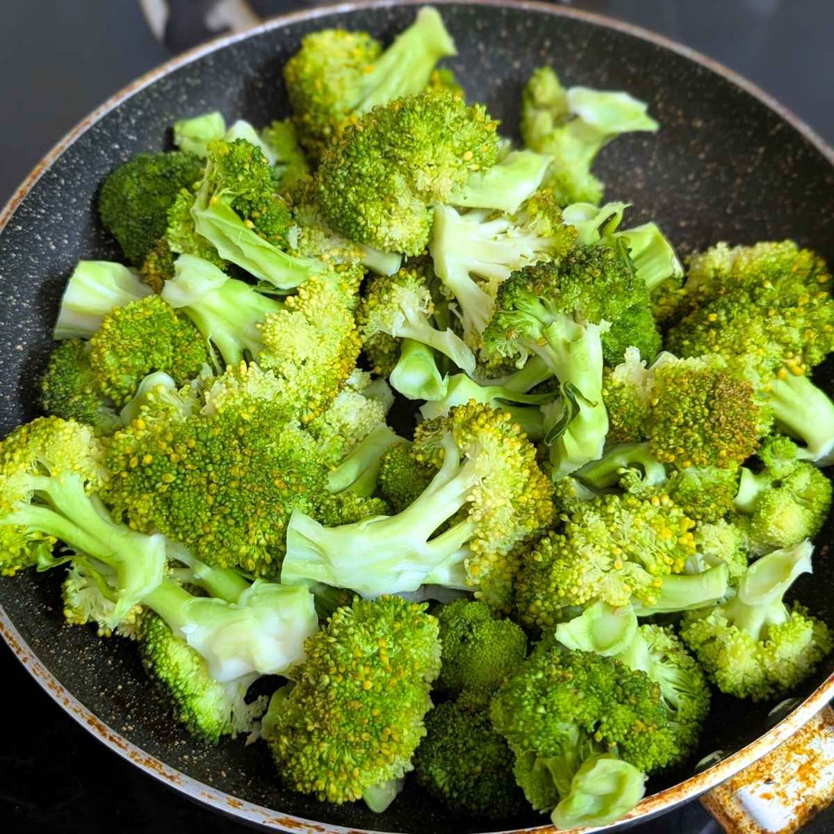 Broccoli florets in a pan