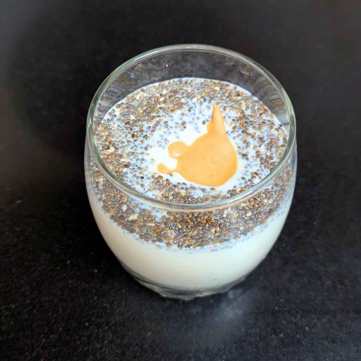 chia seeds, plant milk and peanut butter in a glass